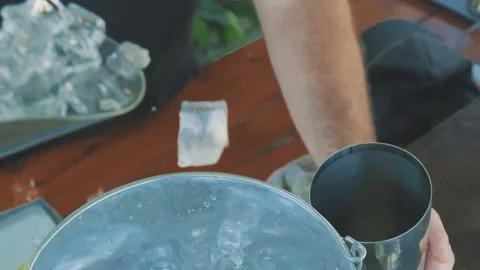 A bartender scooping ice to a cocktail shaker Stock Footage 233997118