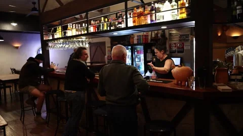 Bartender Serves Drinks to Patrons at Cozy Australian Pub Stock Footage 316292182