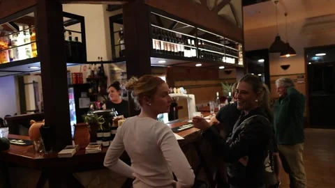 Bartender Serves Drinks to Patrons in Cozy Australian Pub Stock Footage 316730096