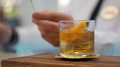 Bartender serves manhattan twist cocktail Stock Footage 101969239