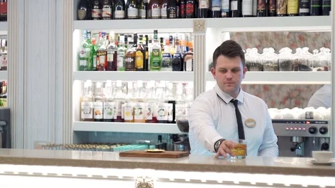 Bartender serves manhattan twist cocktail 1 Stock Footage 101969259