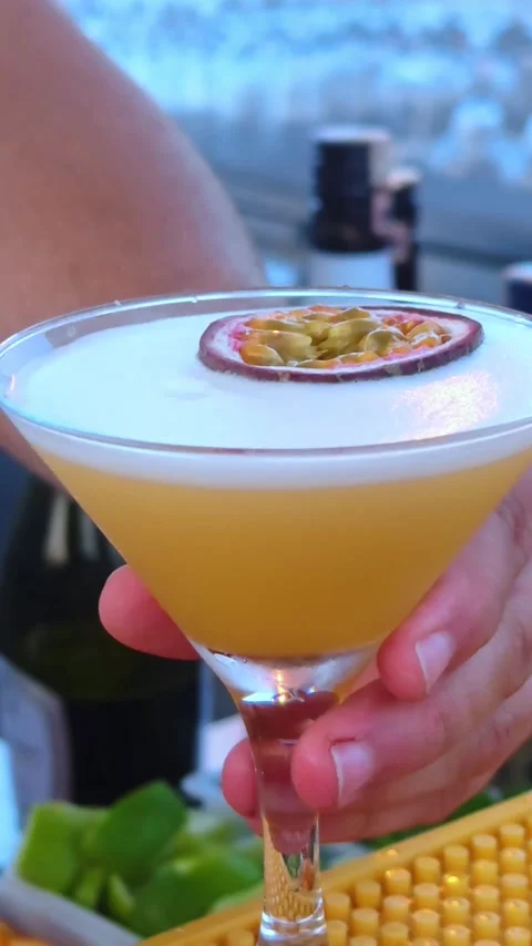 A bartender serves refreshing colorful drink at an outdoor beach bar. Видео 337996102