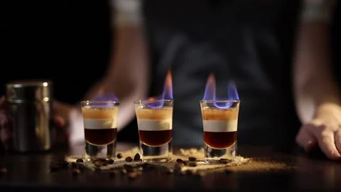 Bartender serving B52 cocktails on fire Stock Footage 131324444
