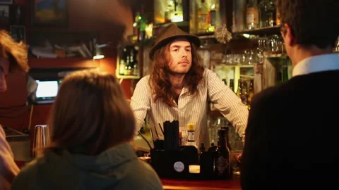 Bartender Serving Customers At Busy Bar Counter Stock Footage 344541016