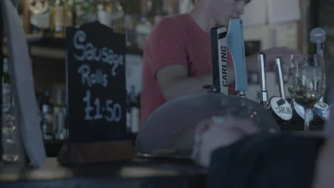 Bartender Serving Drinks at Traditional Pub Counter Stock Footage 343096203