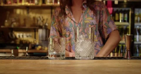 Bartender serving ice into two glasses Stock Footage 203900368