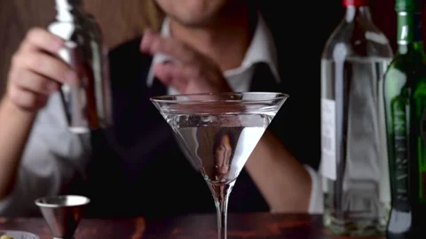 Bartender serving martini in glass at bar	 Stock Footage 143126261