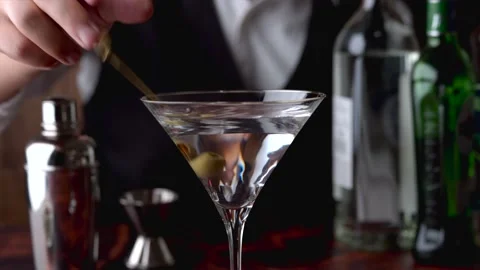 Bartender serving martini in glass at bar	 Stock Footage 143126293