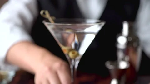 Bartender serving martini in glass at bar	 Stock Footage 143126476