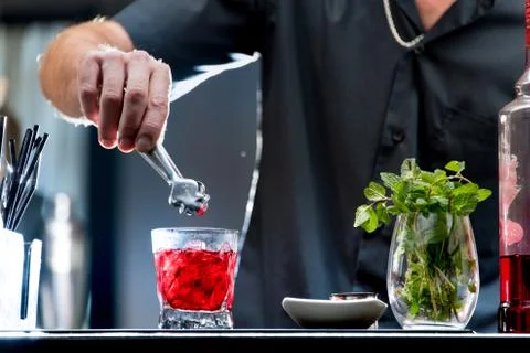 Bartender serving a red cocktail Stock Photos