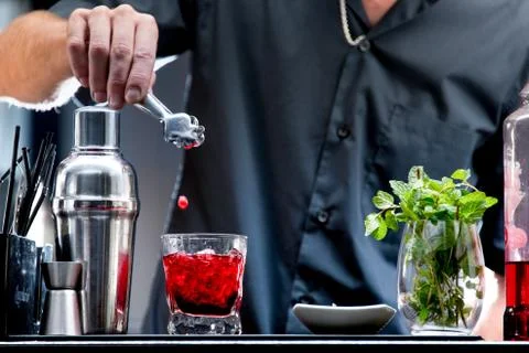 Bartender serving a red cocktail Stock Photos
