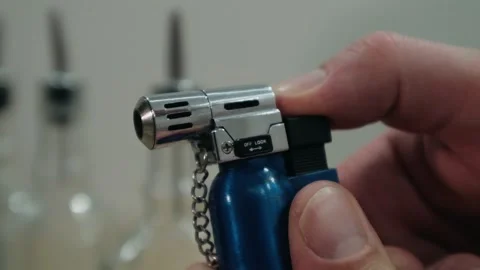 Bartender sets fire to cocktail, burning cinnamon in alcohol drink Stock Footage 131541583