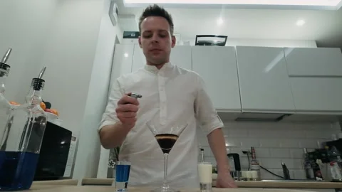 Bartender sets fire to cocktail, burning cinnamon in alcohol drink Stock-Footage 134033190