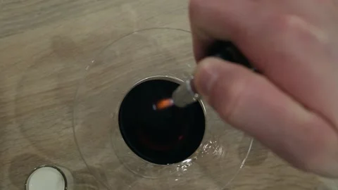 Bartender sets fire to cocktail, burning cinnamon in alcohol drink. Top view 動画素材 134033643