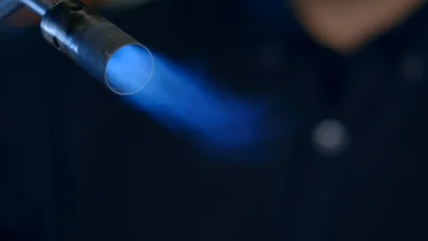 Bartender sets fire to a gas burner to make cocktail hand puts a glass in moss Stock Footage 129474210