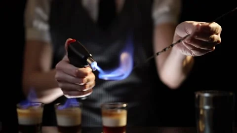 Bartender setting B-52 cocktail on fire Stock Footage 131324501