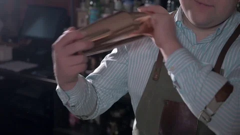 Bartender with shaker making cocktail in modern bar. Handsome barman shake drink Stock Footage 69757647