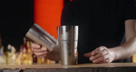 Bartender shaker with mixed cocktail and puts the frozed cocktail glass to the Stock Footage 156476795