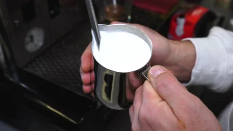 Bartender shakes milk for coffee Stock Footage 139746404