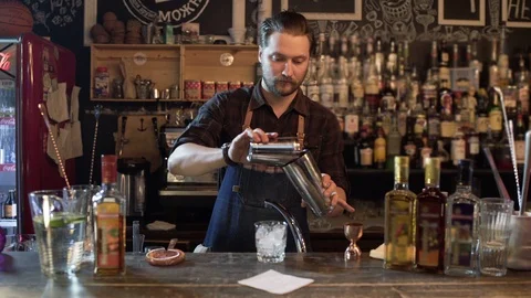 Bartender shaking bottle preparing beverages in bar 스톡 동영상 96241455