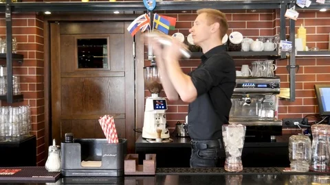 Bartender is shaking bottle preparing beverages in the bar Stock Footage 116624705
