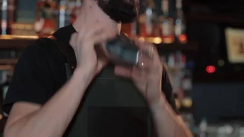 Bartender shaking a cocktail, closeup, slow motion Stock Footage 128676455