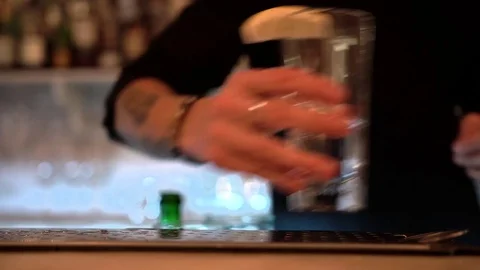 Bartender silhouette put lemon slice on transparent glass with alcohol, close-up Stock-Footage 83335142