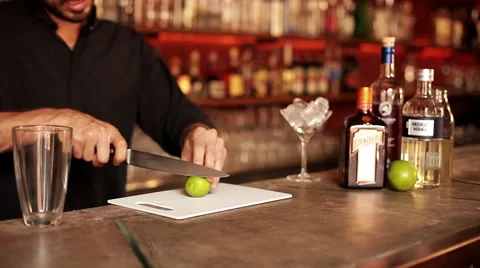 Bartender slicing lime for cocktail Stock Footage 63306009