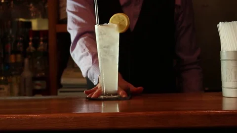 Bartender Sliding Cocktail Towards Camera Stock Footage 70737099