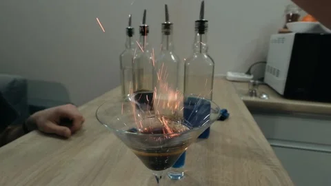 The bartender sprinkles a burning cocktail with ground cinnamon Stock Footage 131540975