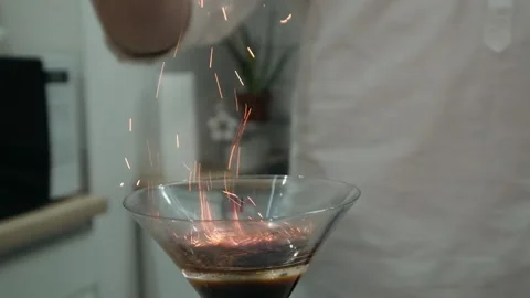 The bartender sprinkles ground cinnamon on a burning alcoholic cocktail Stock Footage 131542236