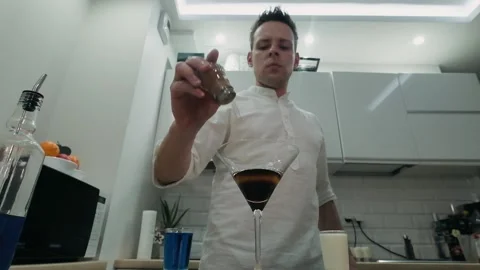 The bartender sprinkles ground cinnamon on a burning alcoholic cocktail Stock Footage 131543207