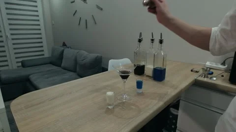 The bartender sprinkles ground cinnamon on a burning alcoholic cocktail Stock Footage 131544174