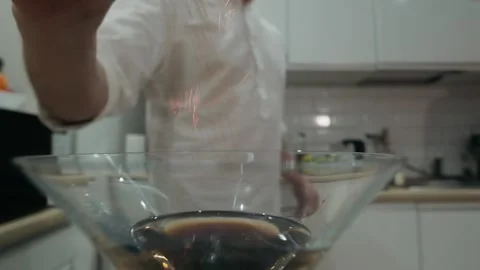 Bartender sprinkles ground cinnamon on a burning alcoholic cocktail. Close up Stock Footage 131544968