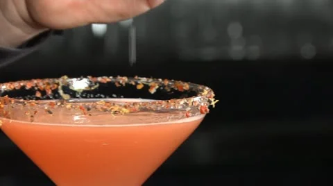 Bartender sprinkles salt onto a martini Stock Footage 20462592