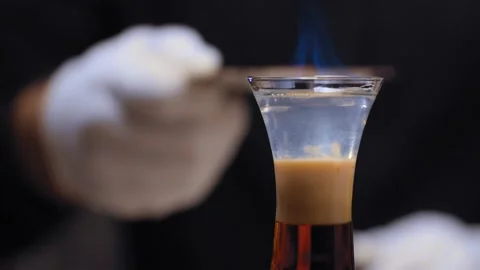 Bartender sprinkling with cinnamon burning short drink Stock Footage 131445153