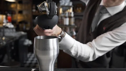 Bartender squeezes juice to the cocktail shaker, making of the cocktails, barman Stock Footage 101056997