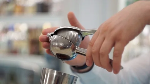Bartender squeezes lemon juice into a cocktail 1 Stock Footage 101968865