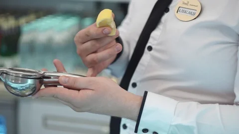 Bartender squeezes lemon juice into a cocktail 3 Stock Footage 101968962