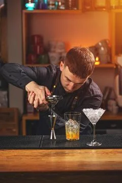 Bartender squeezes lemon Stock Photos