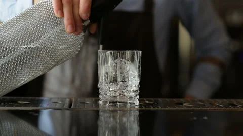Bartender squirting on the ice of the siphon Stock Footage