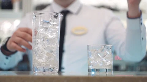 Bartender stir the ice in a mixing glass with a spoon Stock Footage 101968998