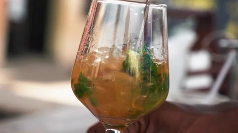 Bartender stirring and making passion fruit mojito cocktail, slow motion Stock Footage 230080337