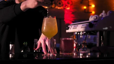 Bartender stirring cocktail with bar spoon bar counter. Cocktail Making Concept Stock Footage 269560173