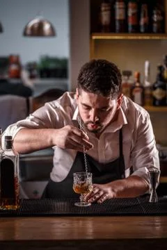 Bartender is stirring cocktail Stock Photos