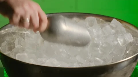 The bartender is stirring with a spatula and taking ice from the ice bucket Stock Footage 185024398