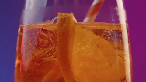 Bartender stirs and drops striped straw into glass with cold summer cocktail Stock Footage 246854796