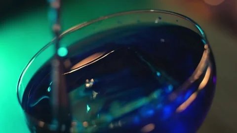 Bartender stirs blue cocktail with ice Stock Footage 196981989