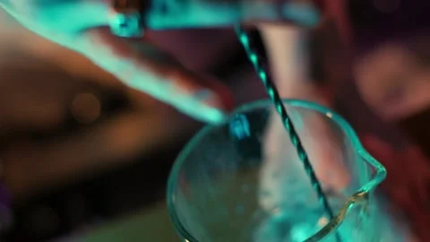 Bartender stirs cocktail with bar spoon Stock Footage 196981966