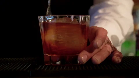 The bartender stirs her cocktail. Stock Footage 244941531